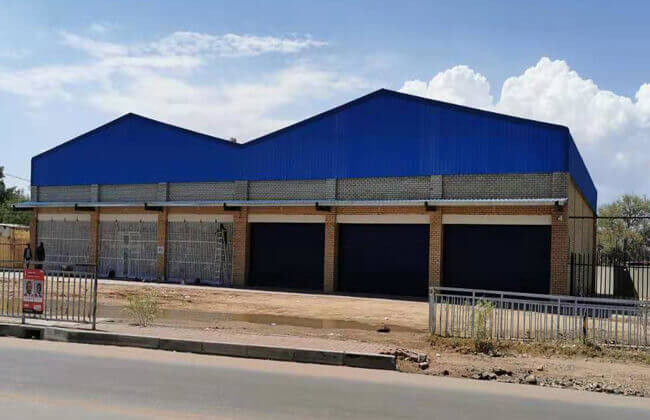 Construção de loja de aço de construção do metal pré-fabricado do armazém de armazenamento da exploração agrícola da construção de aço da casa pré-fabricada da oficina em Botswana